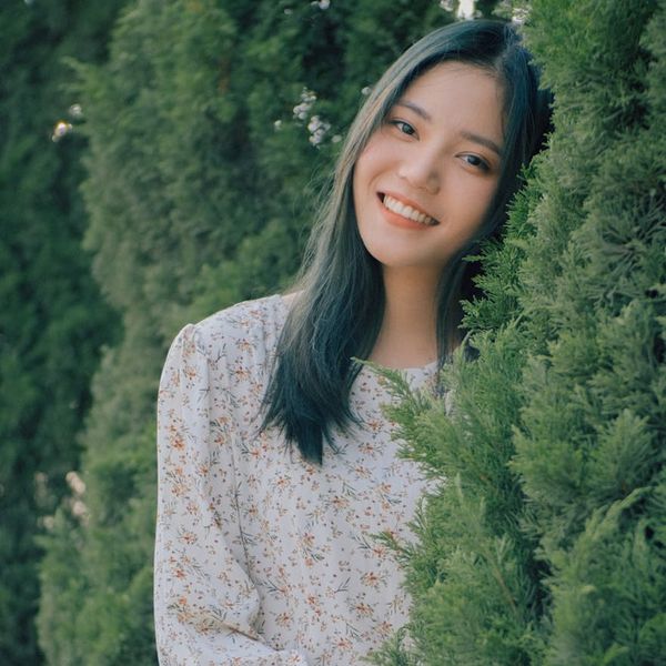 Headshot of a happy woman in a softly lit environment.