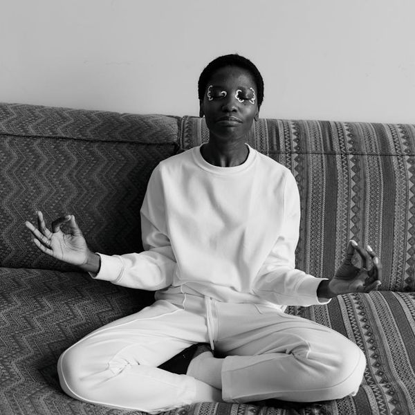 Person in a comfortable cross-legged yoga pose, eyes closed.